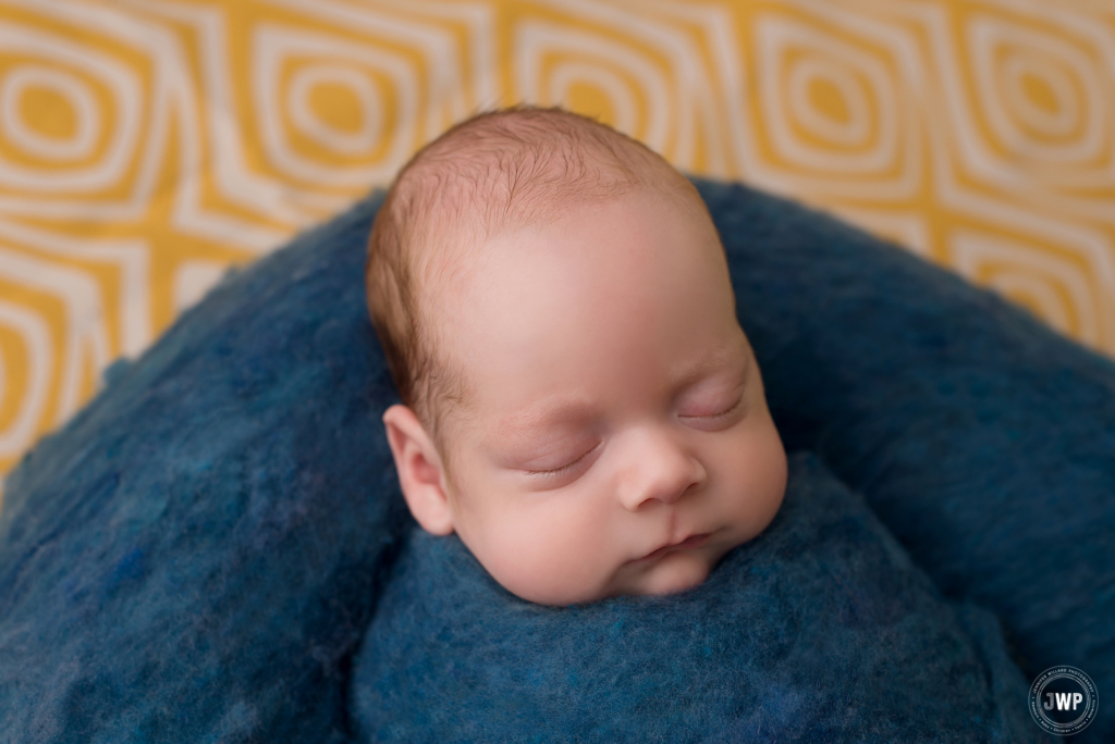 baby boy blue wool fluff wrap yellow pattern backdrop Kingston newborn photographer