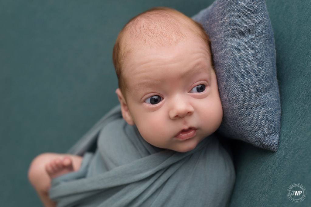 baby boy blue wrap eyes open blue pillow Kingston newborn photographer