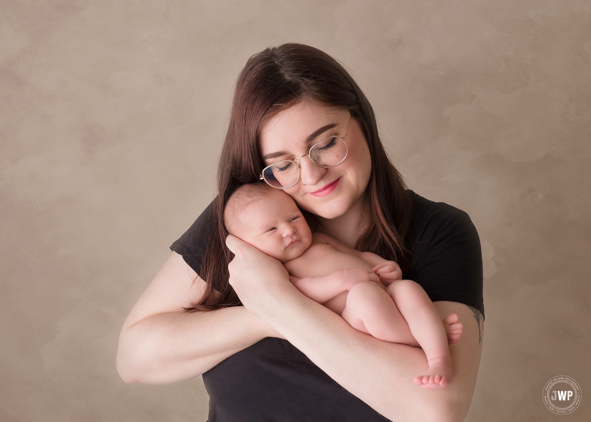 Mother snuggling newborn girl brown background Kingston baby photographer