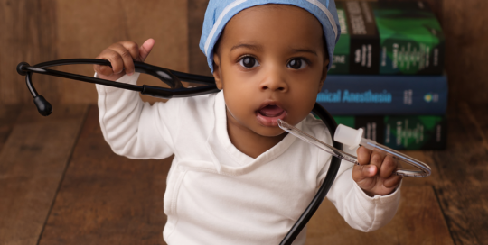 baby girl with surgeons hat and stethoscope