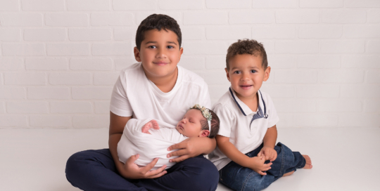 baby girl big brothers white brick backdrop Kingston newborn photographer