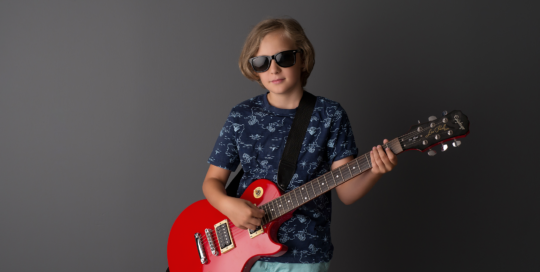 boy red guitar grey backdrop sunglasses Kingston children photographer