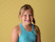 girl smiling yellow backdrop Kingston children photography