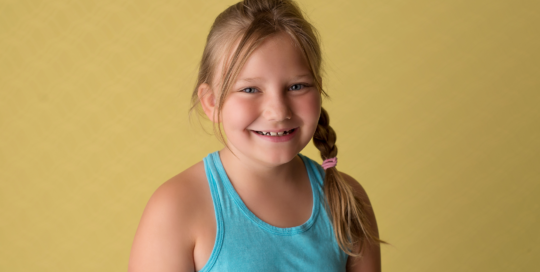 girl smiling yellow backdrop Kingston children photography