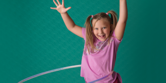 hula hoop girl green backdrop purple shirt Kingston family photographer