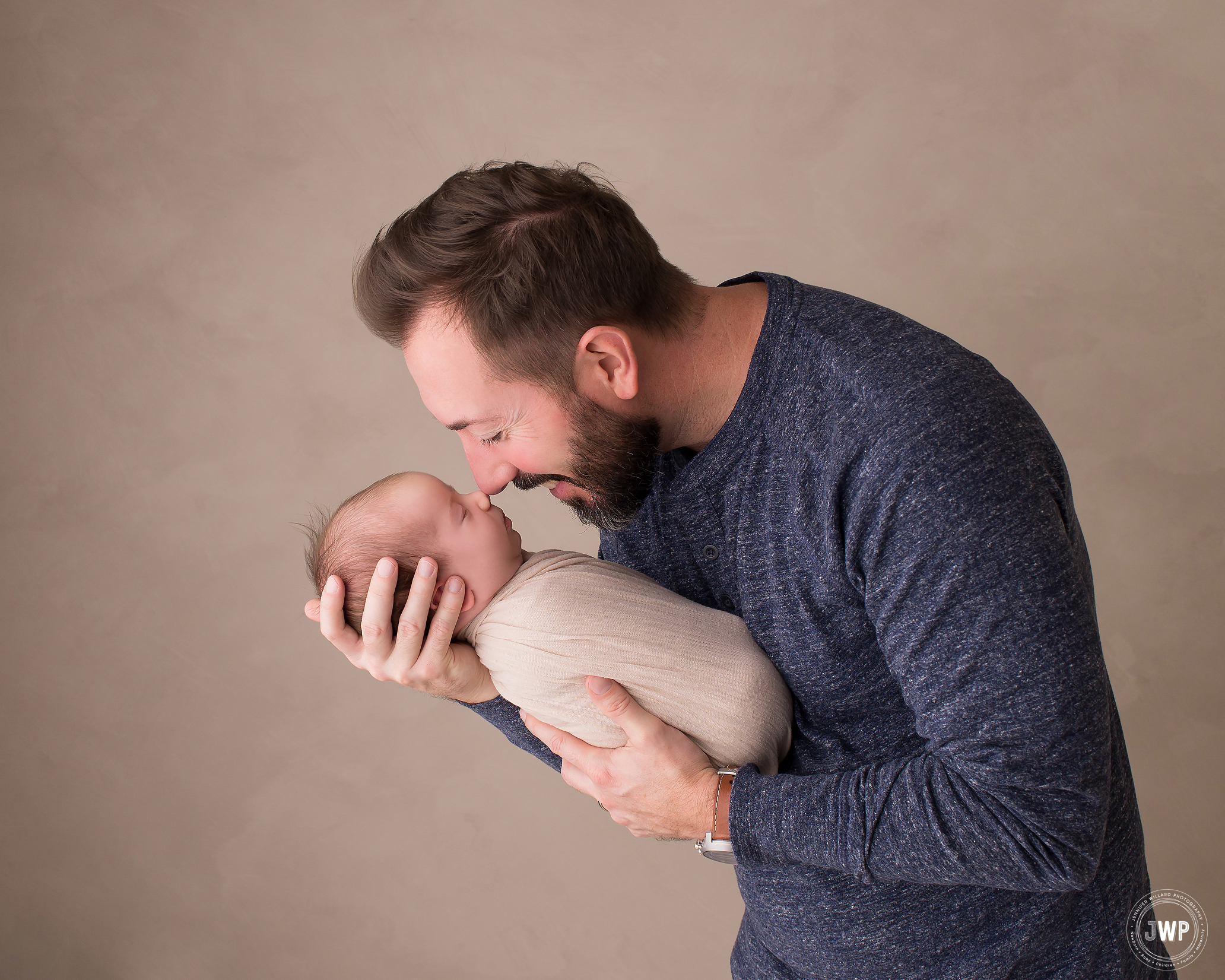 infant girl wrapped Fathers arms Belleville newborn photographer