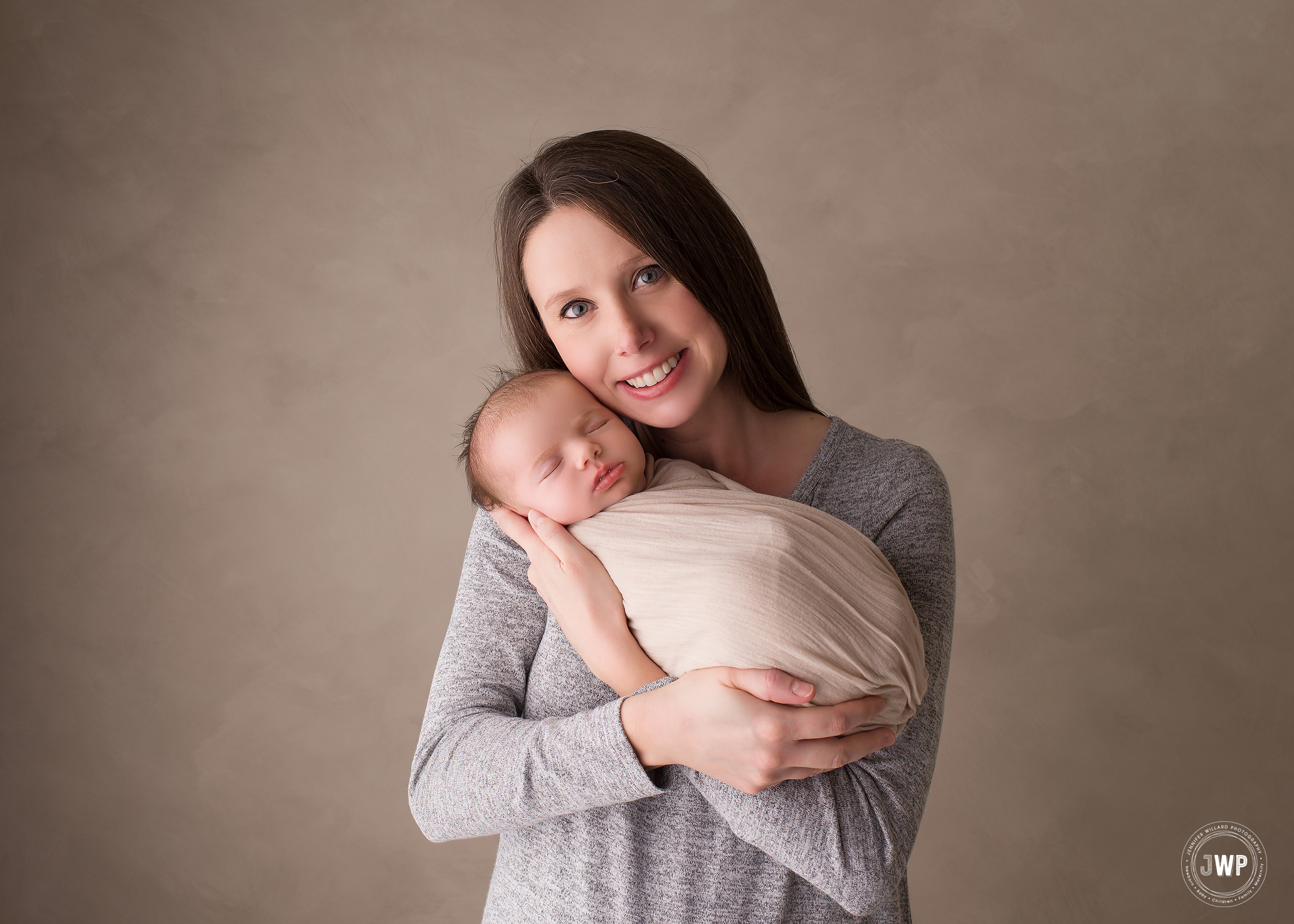 newborn girl wrapped cream wrap Mothers arms Belleville baby photographer