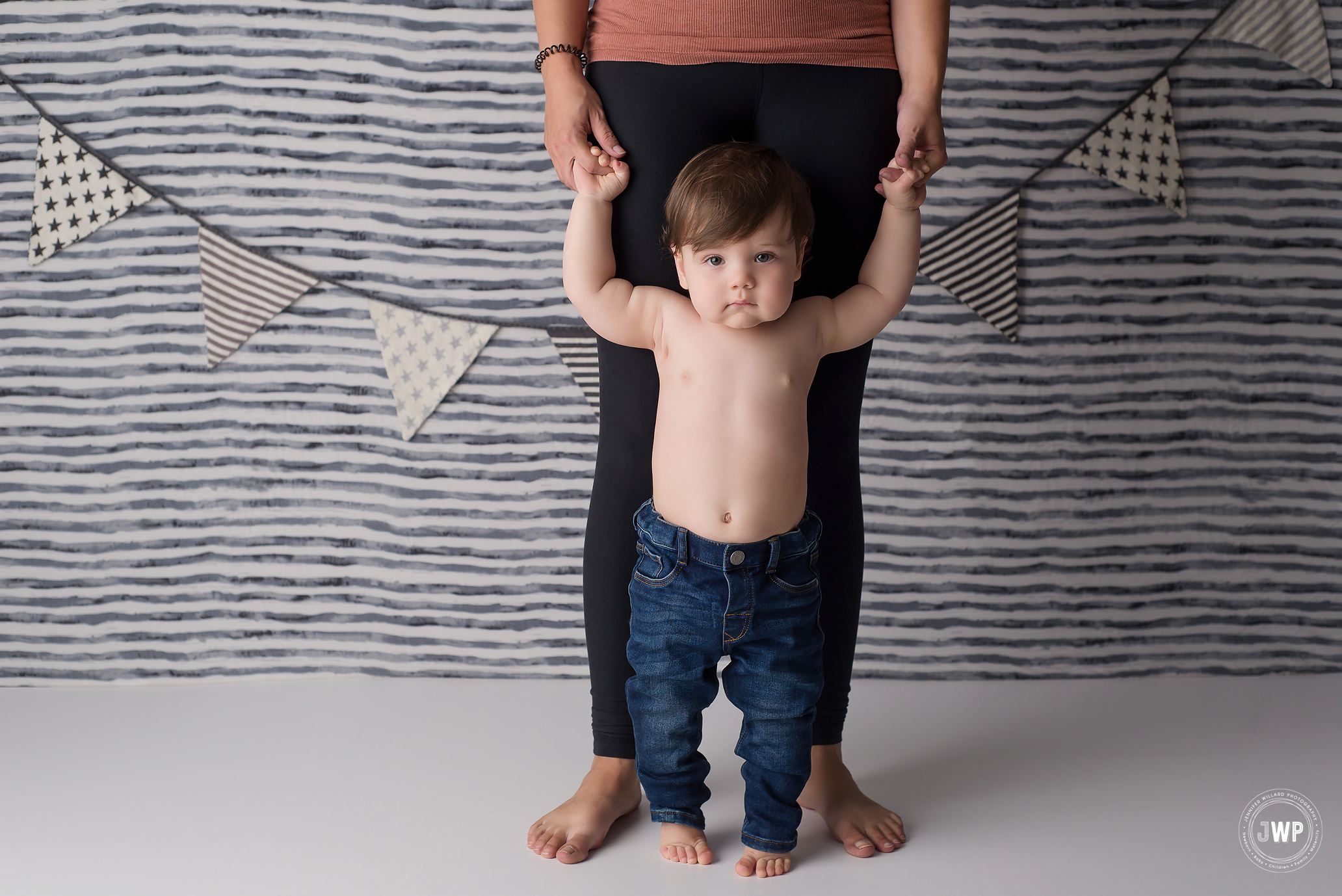 first birthday milestone grey striped backdrop mothers hands Kingston photographer