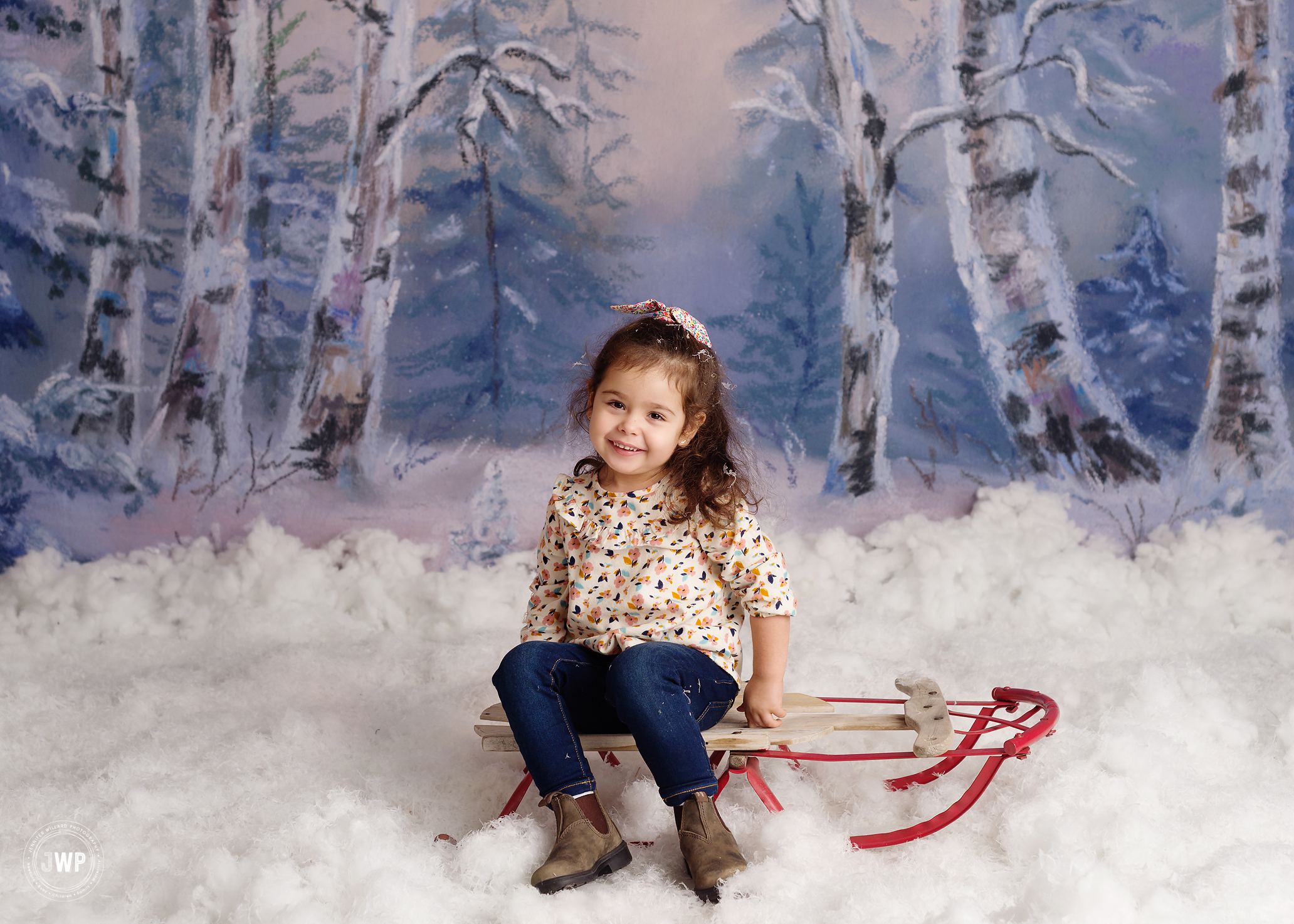 little girl sitting on sleigh in snow Winter trees Kingston mini session photography