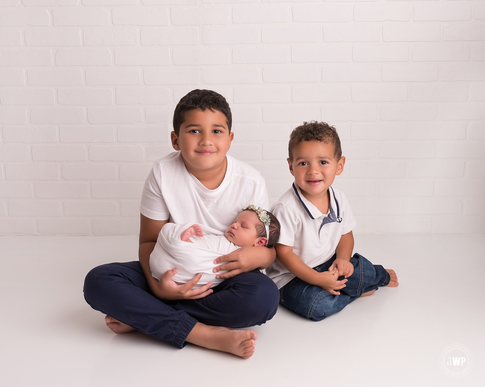 baby girl big brothers white brick backdrop Kingston newborn photographer