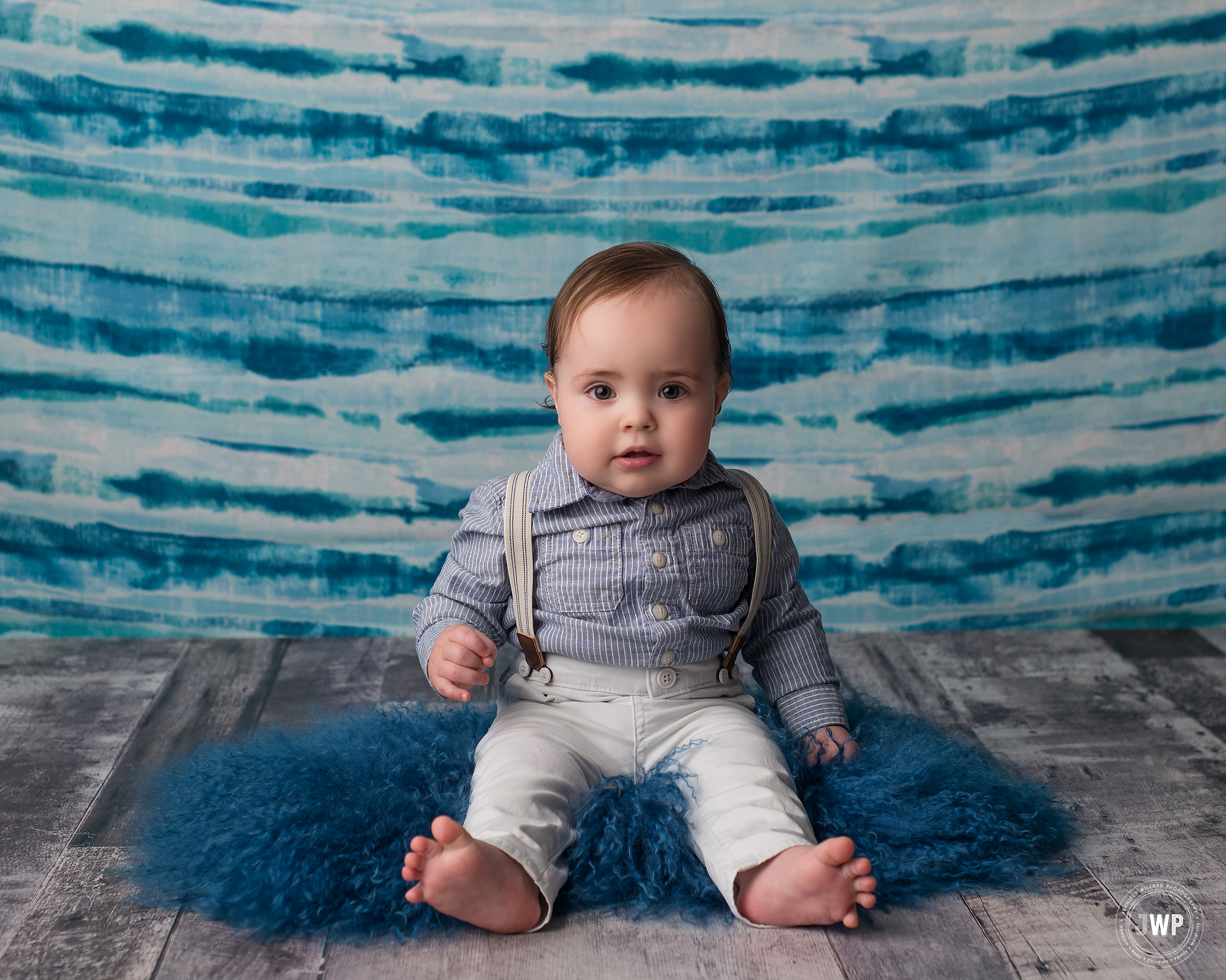 baby boy sitting blue backdrop grey wood floor Kingston first birthday photographer