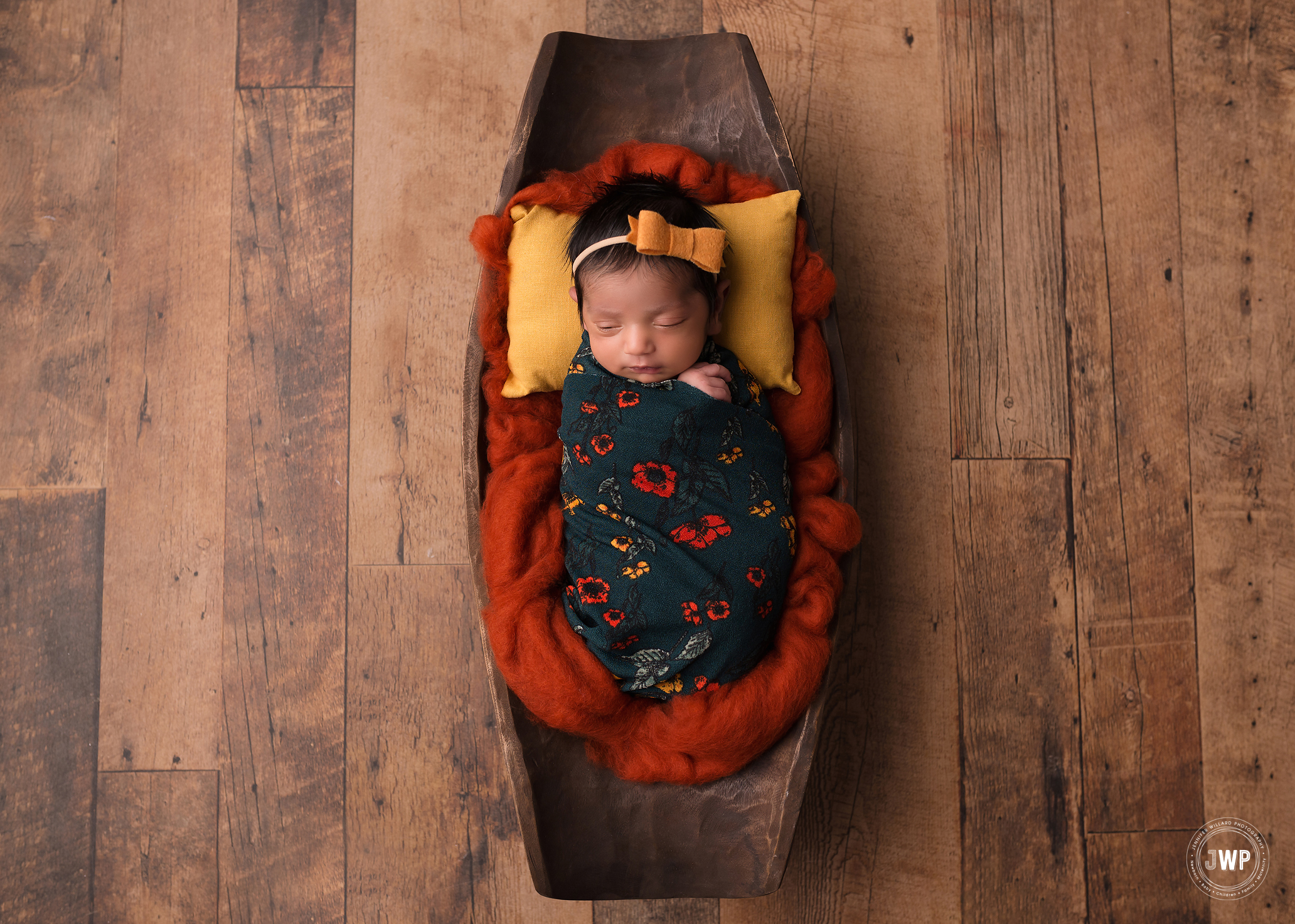 newborn girl green wrap orange yellow pillow Kingston baby photographer