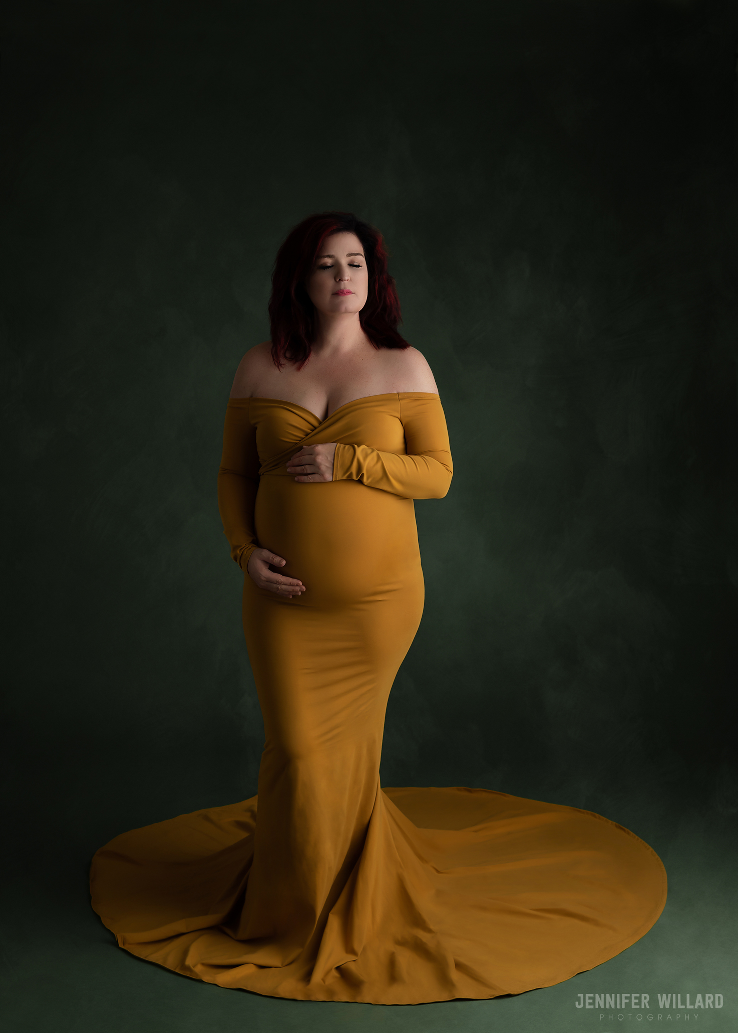 mustard yellow dress on pregnant mother on green backdrop